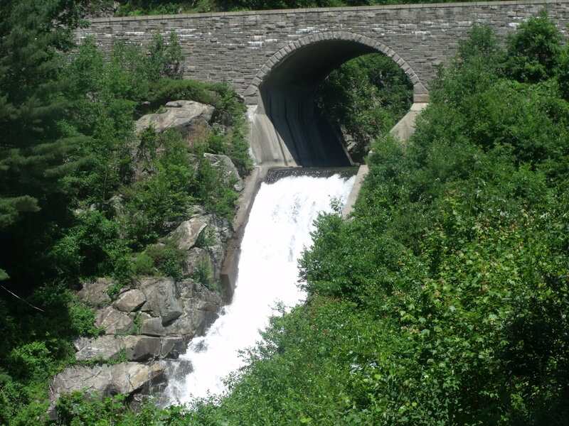 Waterfall under stone bridge