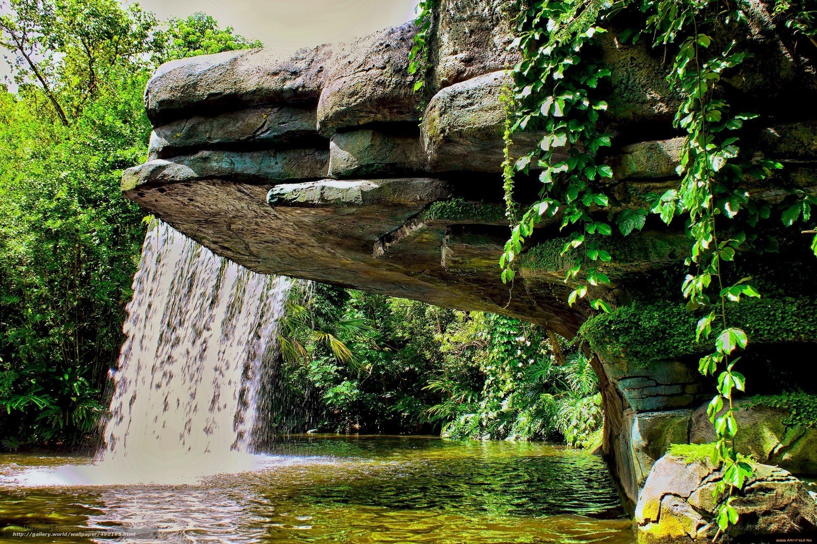 Waterfall under stone bridge