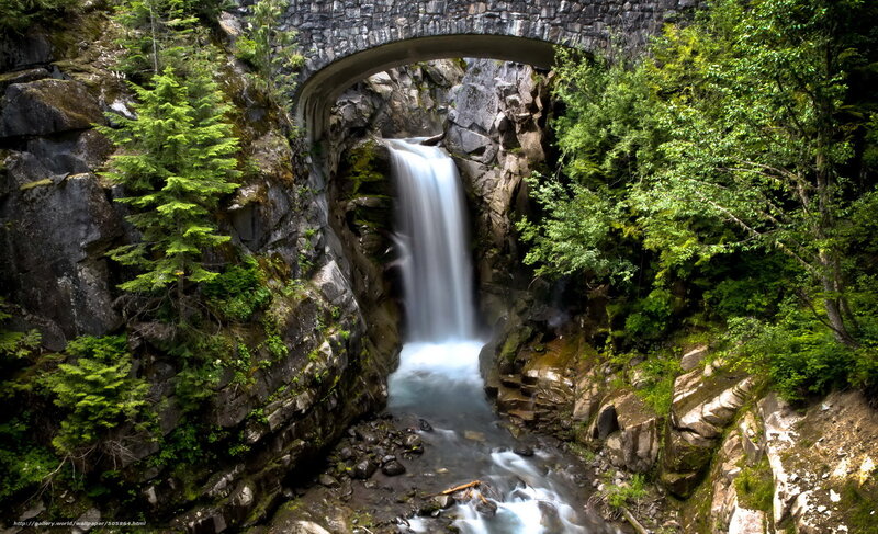 Waterfall under stone bridge