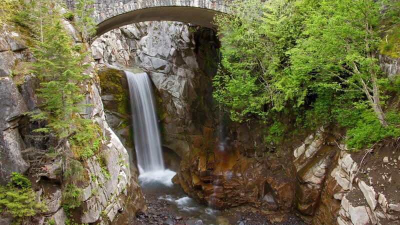 Waterfall under stone bridge