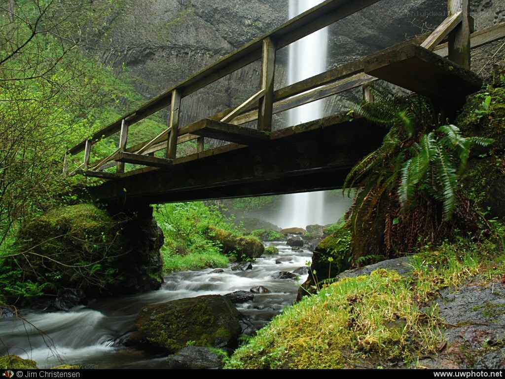 Waterfall under wooden bridge