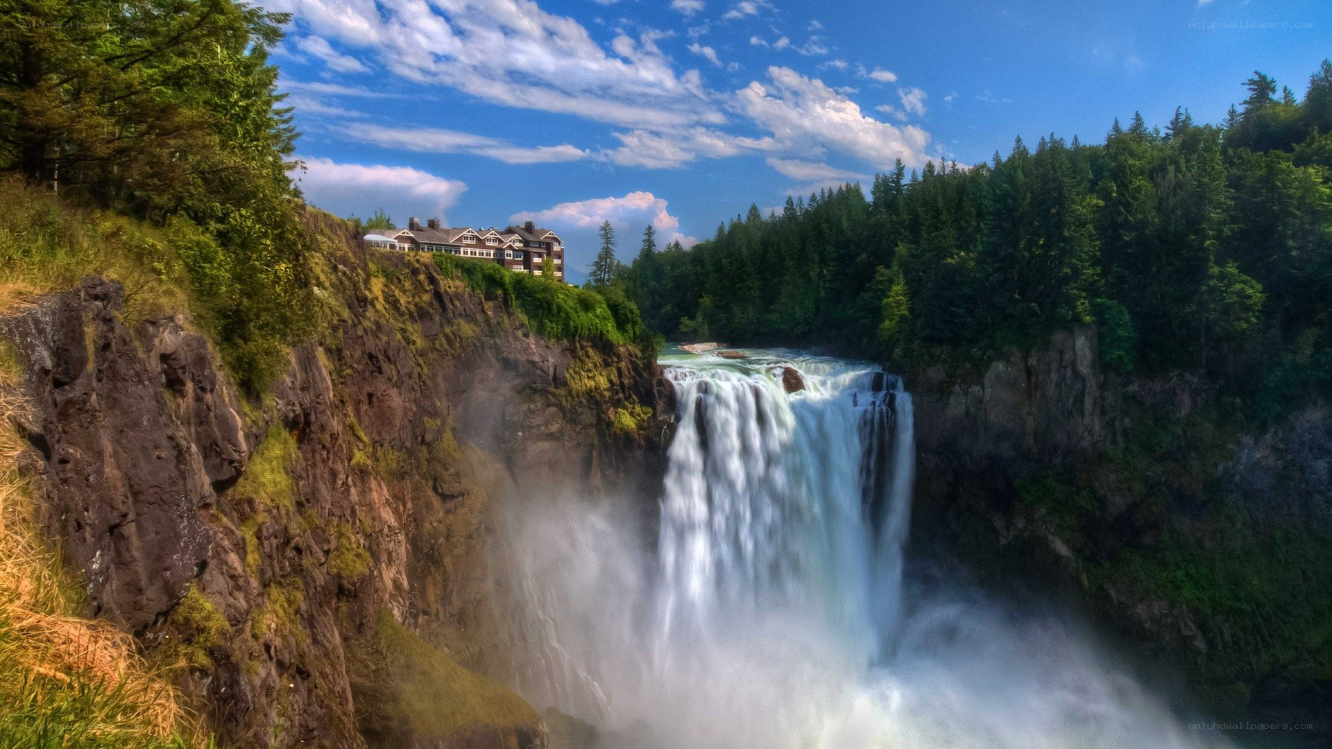 Waterfall with building on cliff