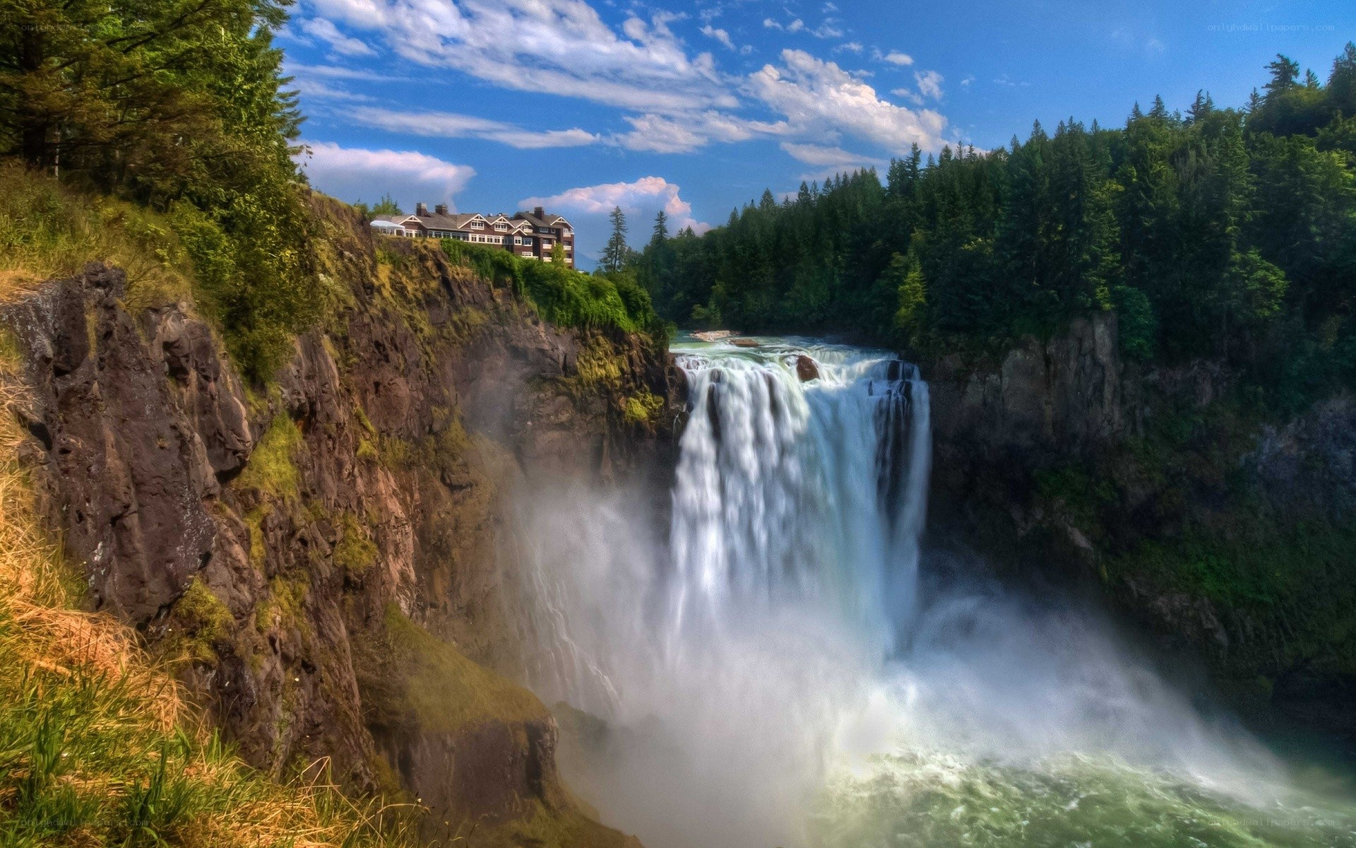 Waterfall with building on cliff