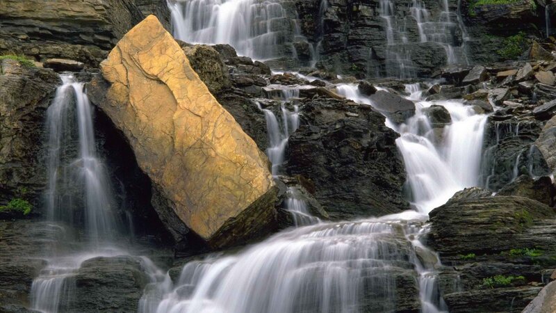 Waterfall with large golden rock