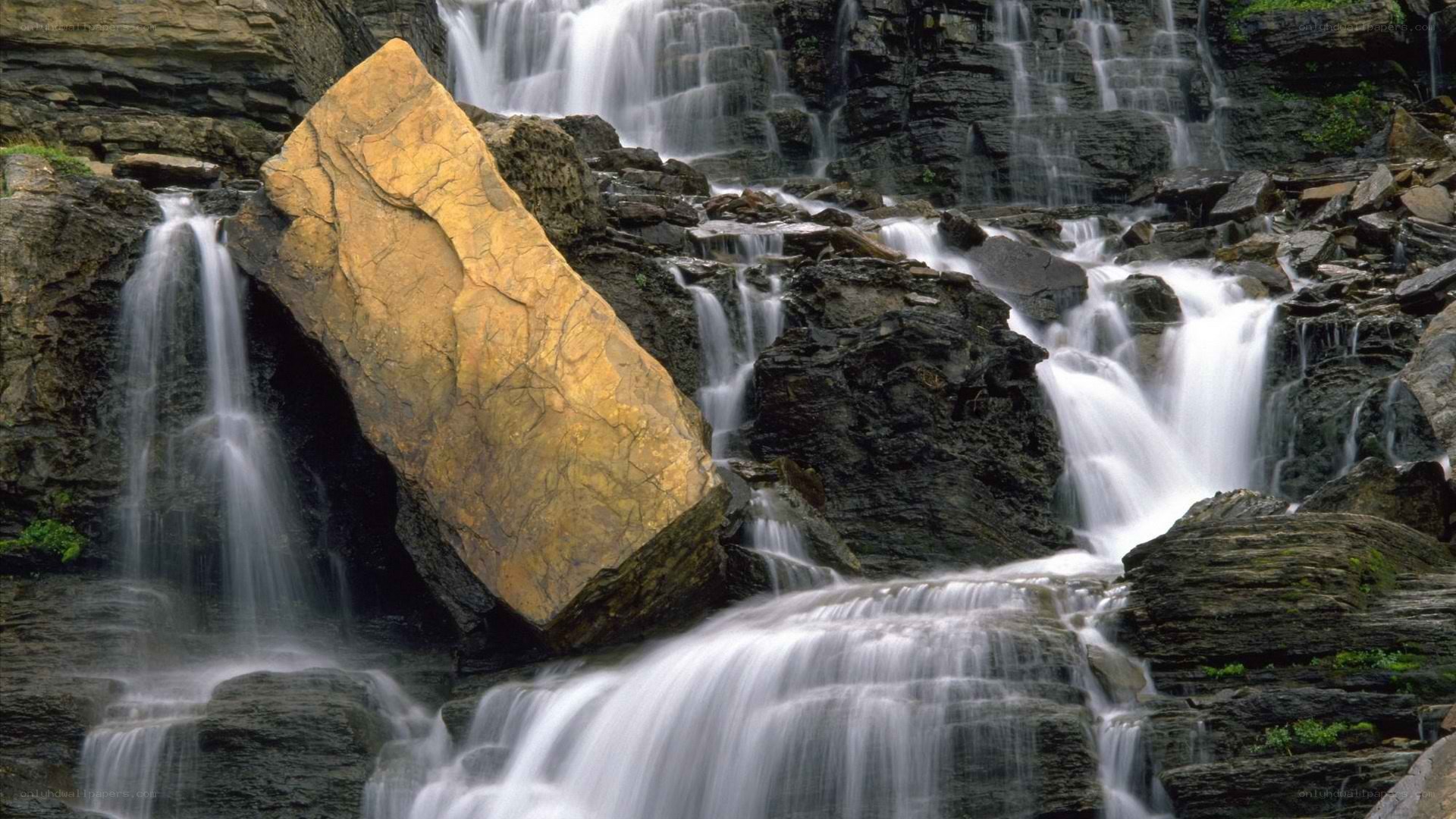 Waterfall with large golden rock