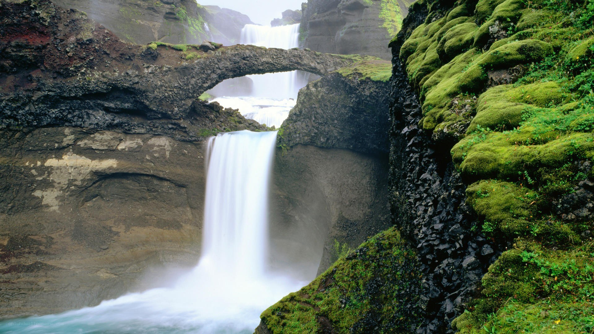 Waterfall with natural rock arch