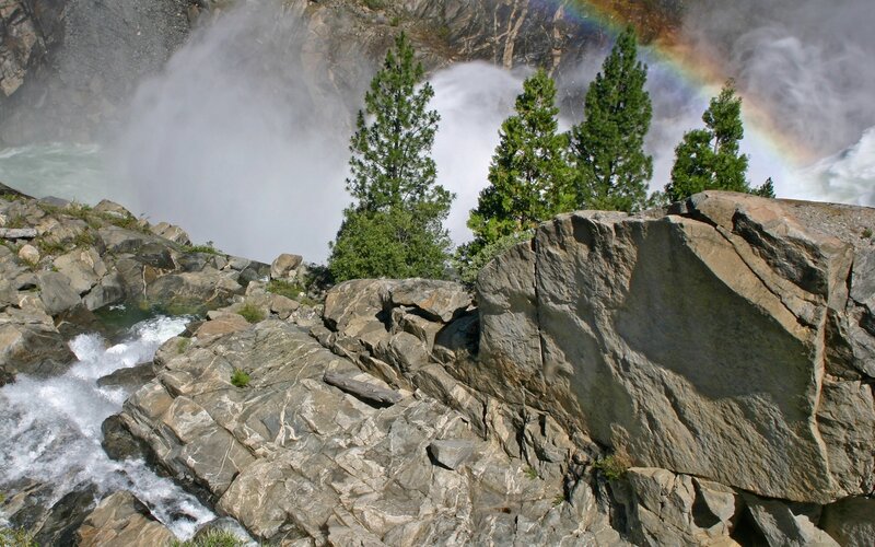 Waterfall with rainbow and rocks
