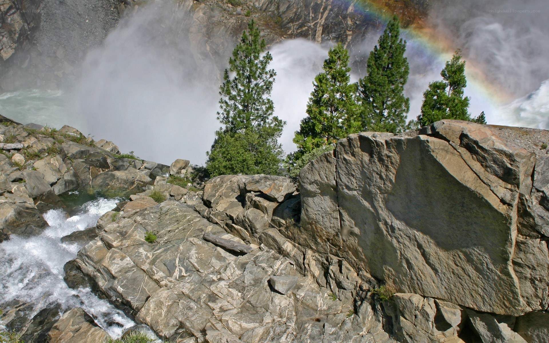 Waterfall with rainbow and rocks