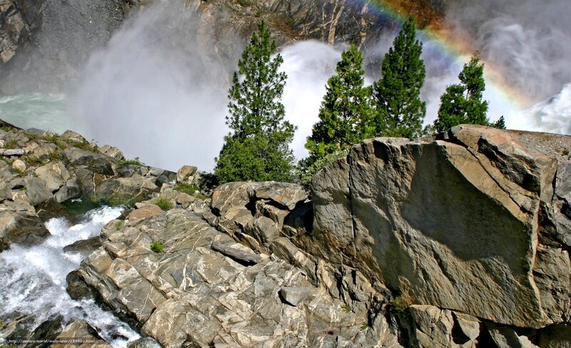 Waterfall with rainbow and rocks