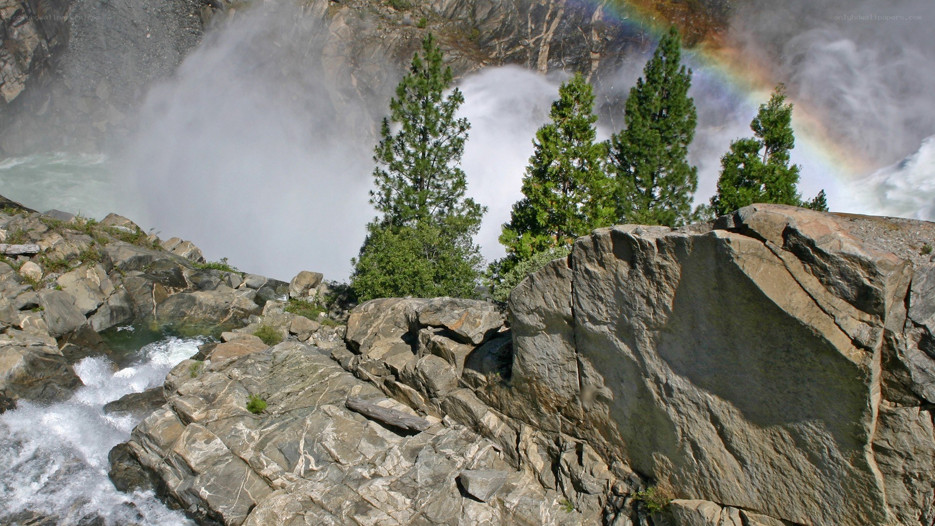 Waterfall with rainbow and trees