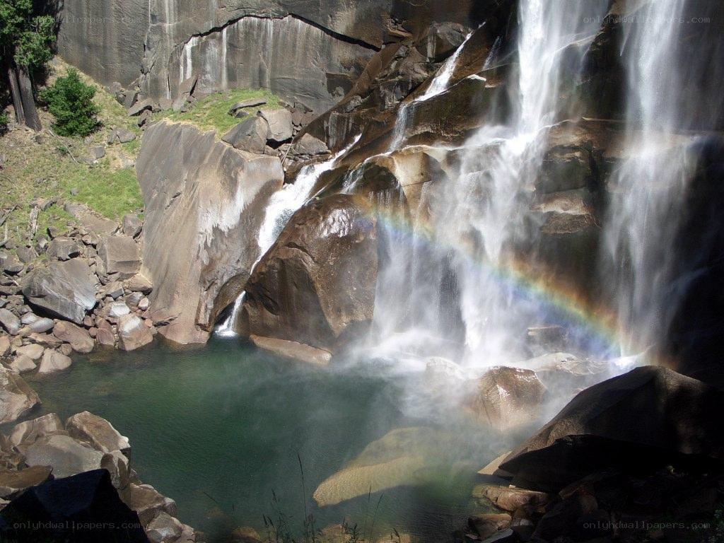 Waterfall with rainbow in a canyon
