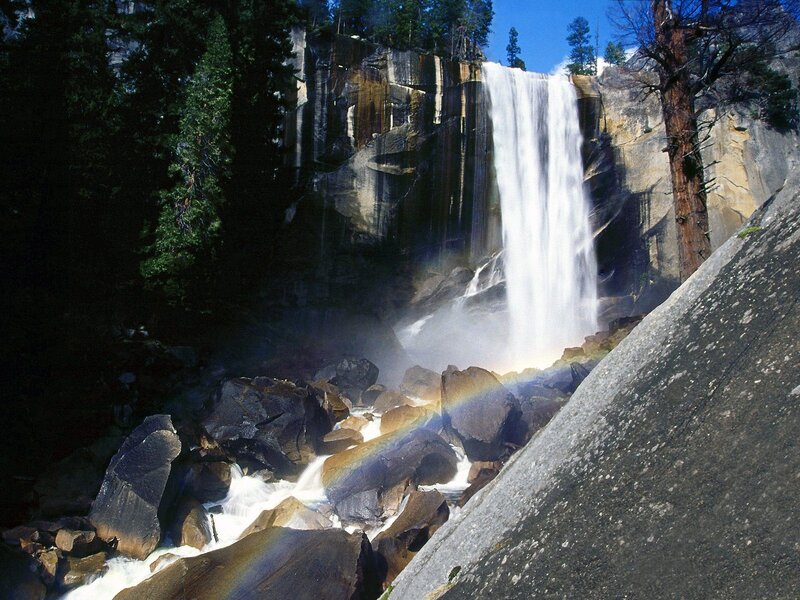 Waterfall with rainbow in forest