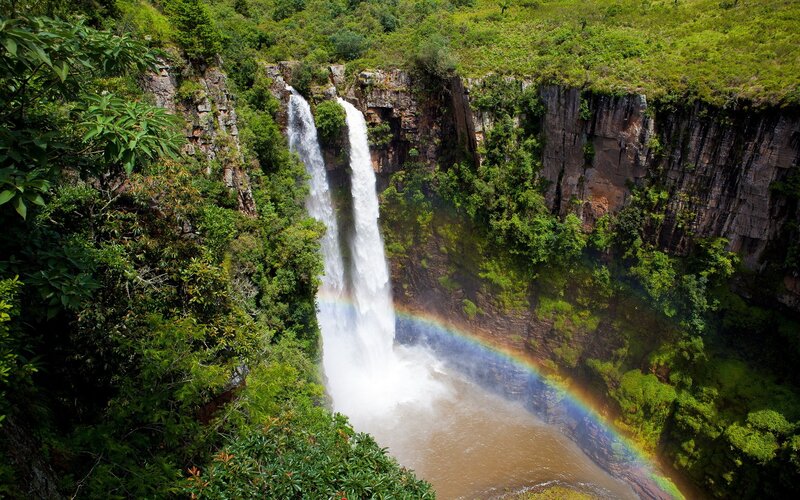Waterfall with rainbow in forest