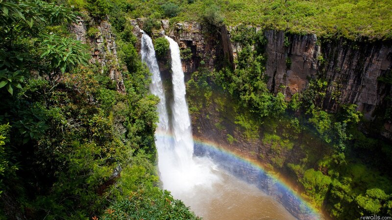 Waterfall with rainbow in forest