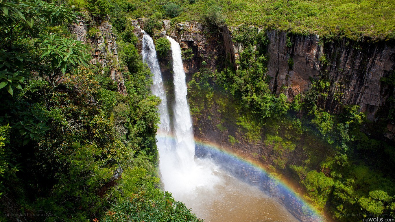 Waterfall with rainbow in forest