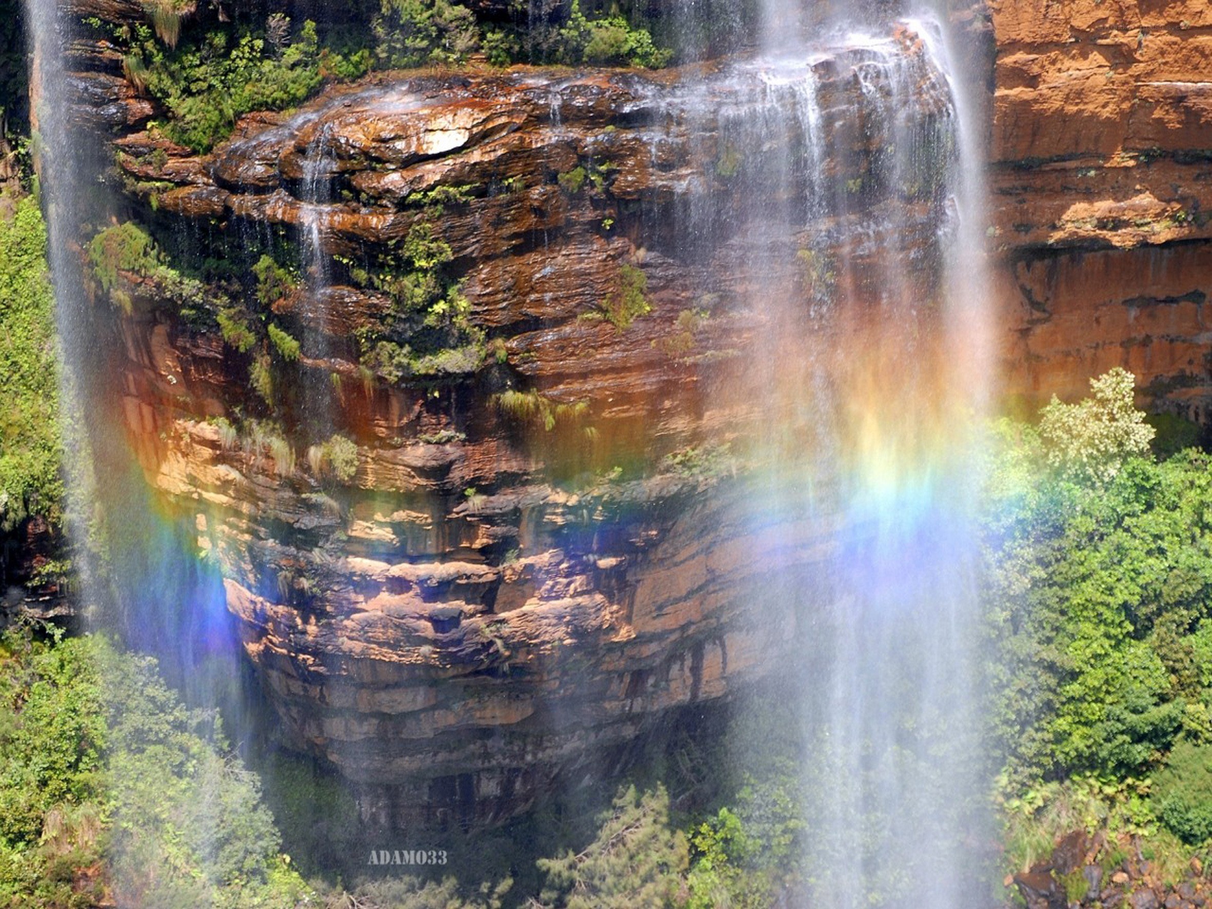 Waterfall with rainbow in forest