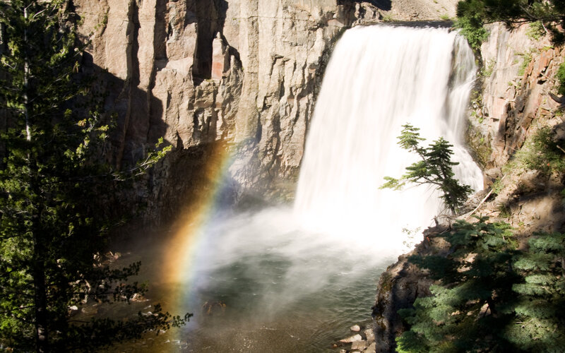 Waterfall with rainbow in forest