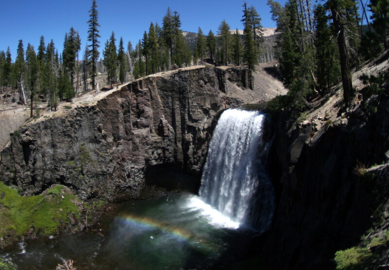 Waterfall with rainbow in forest
