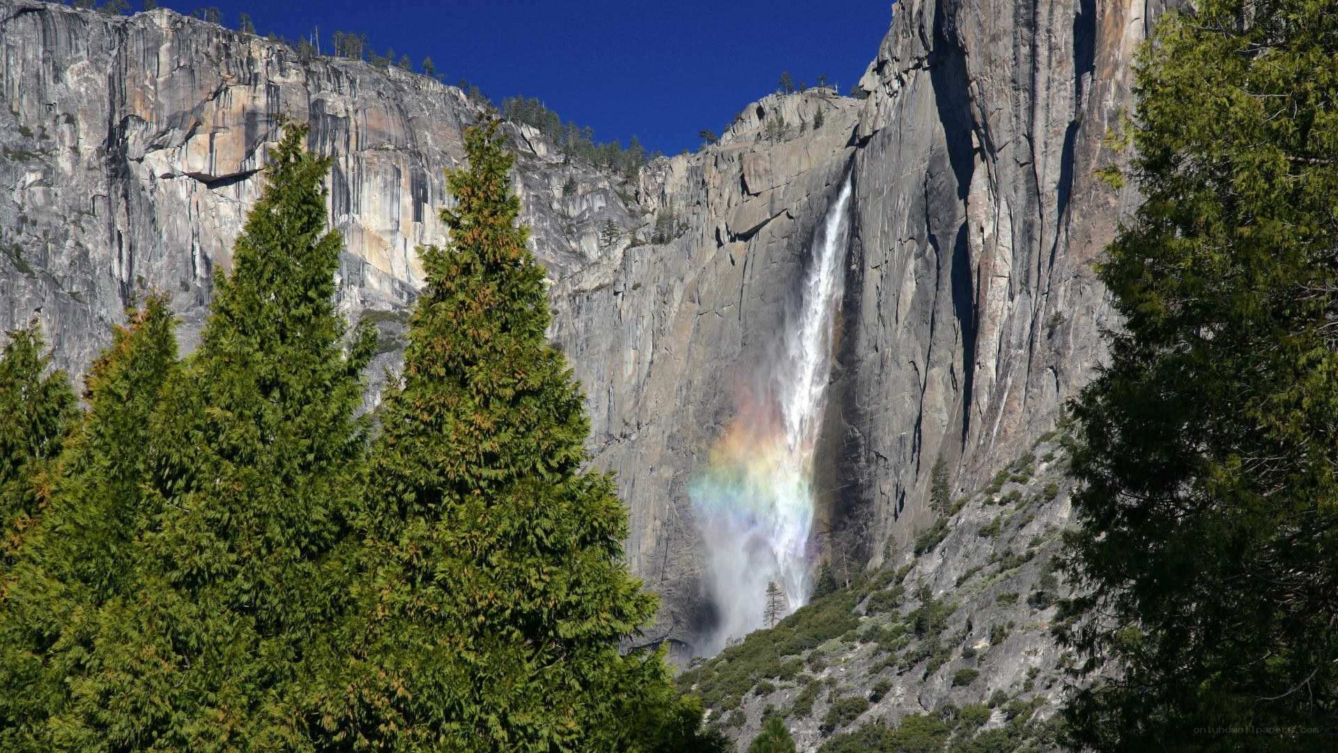 Waterfall with rainbow in Yosemite