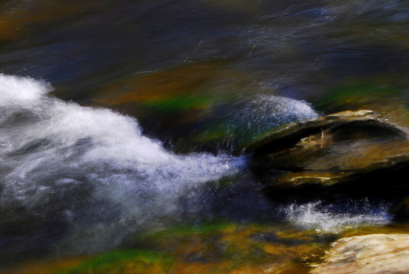 Waterfall with rainbow reflections