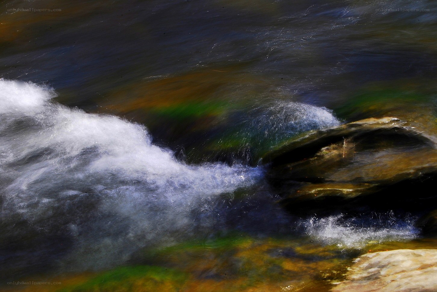 Waterfall with rainbow reflections