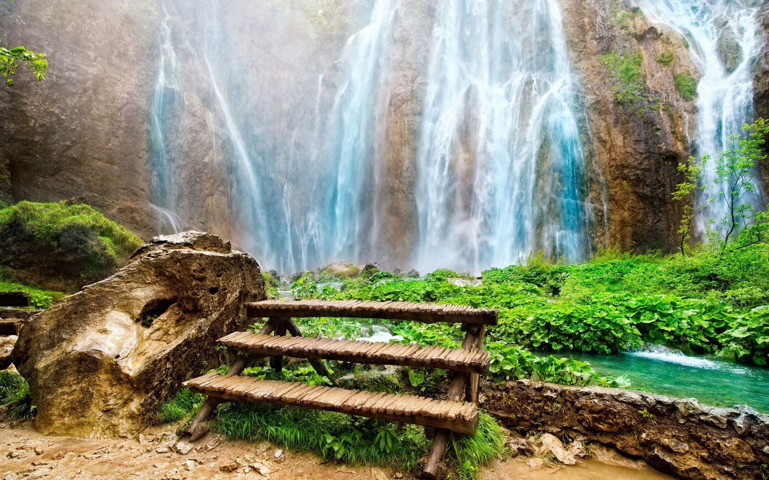 Waterfall with wooden bench