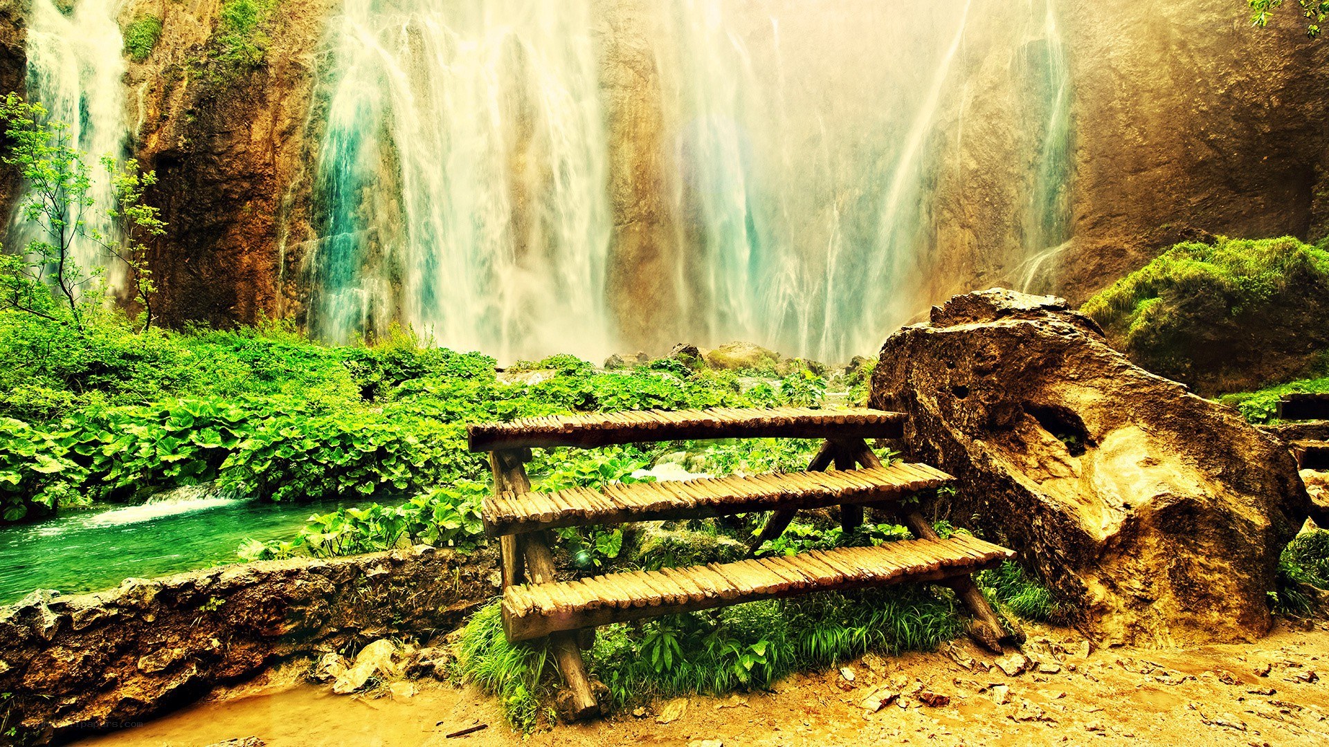 Waterfall with wooden bench