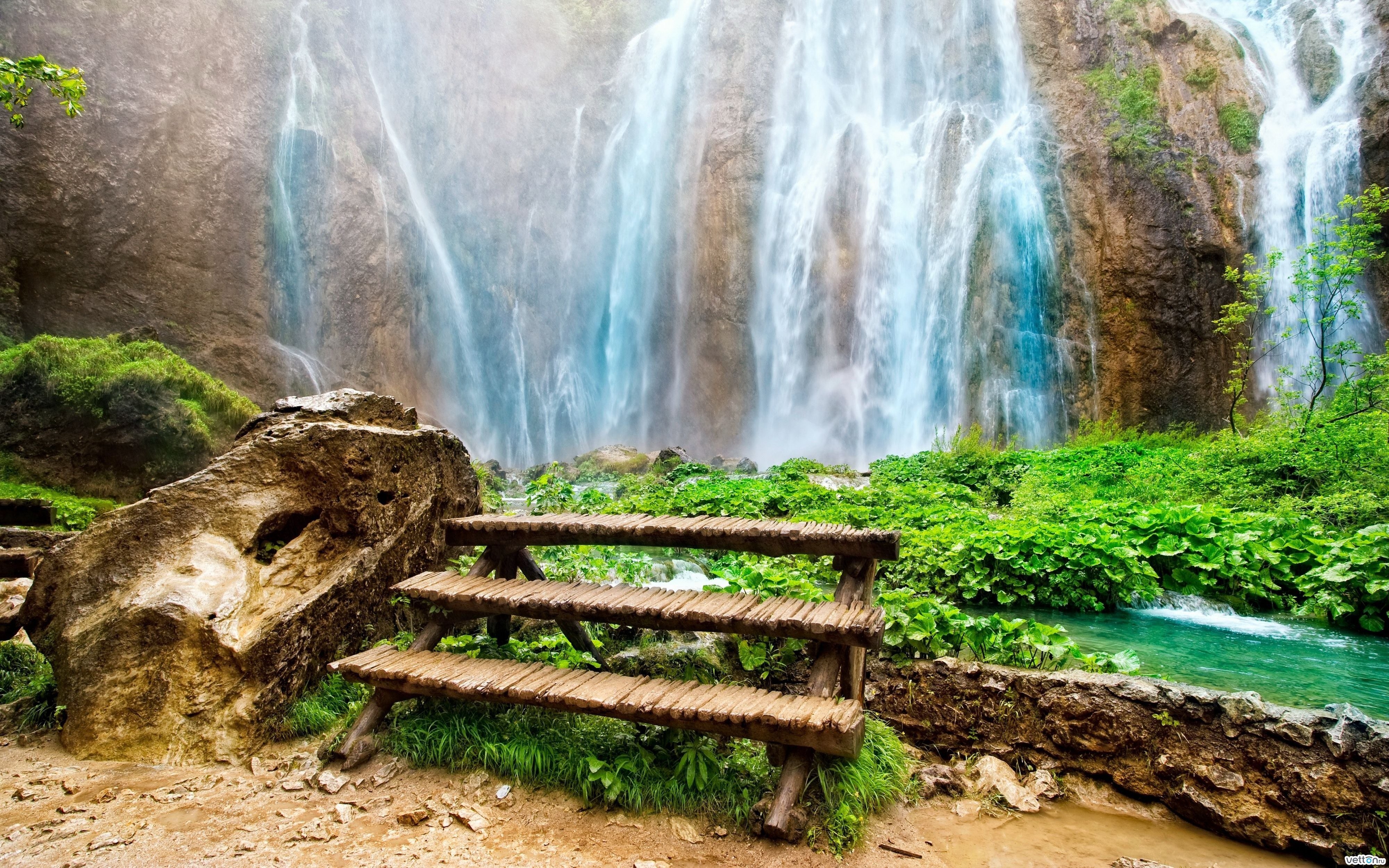 Waterfall with wooden bench
