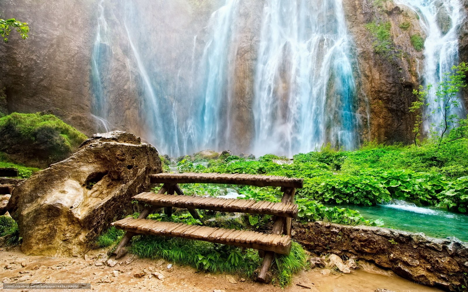 Waterfall with wooden bench