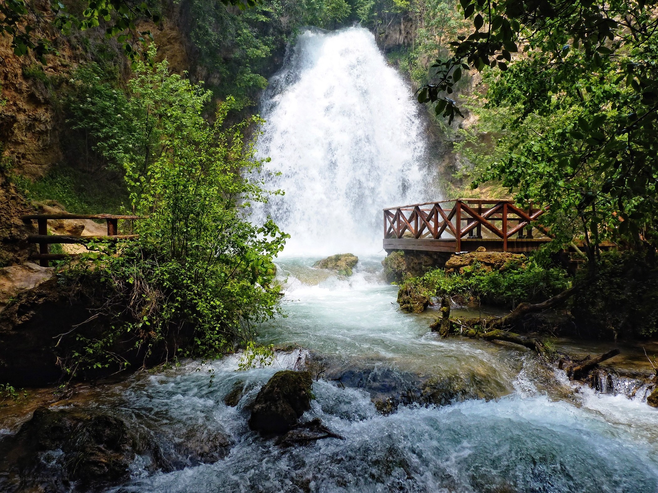 Waterfall with wooden bridge