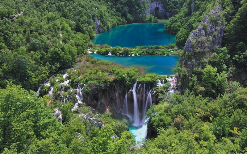 Waterfalls and turquoise lakes in a forest