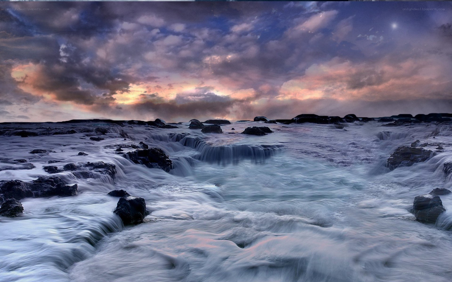 Waterfalls at coastal rocks