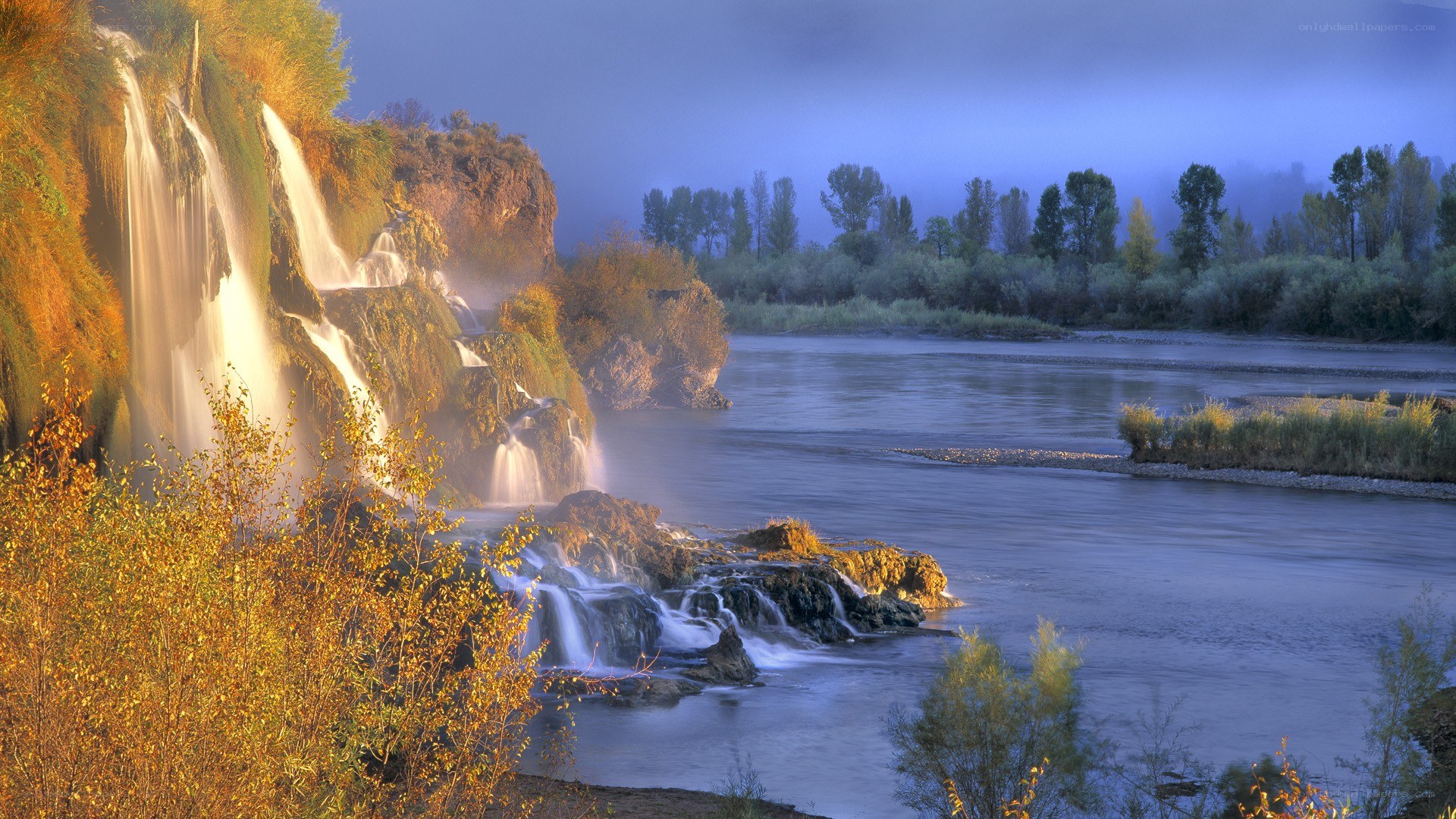 Waterfalls at dawn by a river