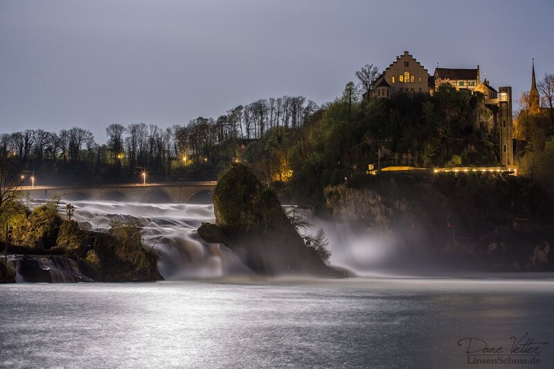 Waterfalls at dusk with castle