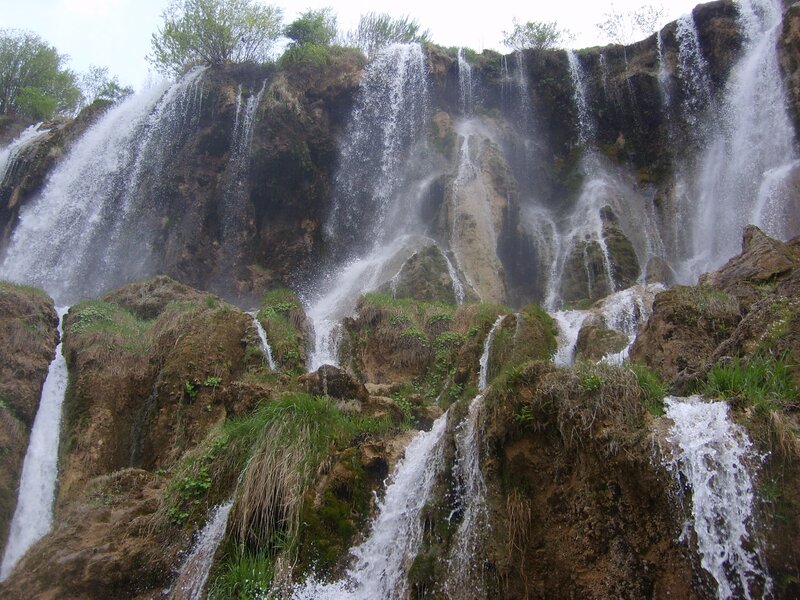 Waterfalls cascading down a rocky cliff