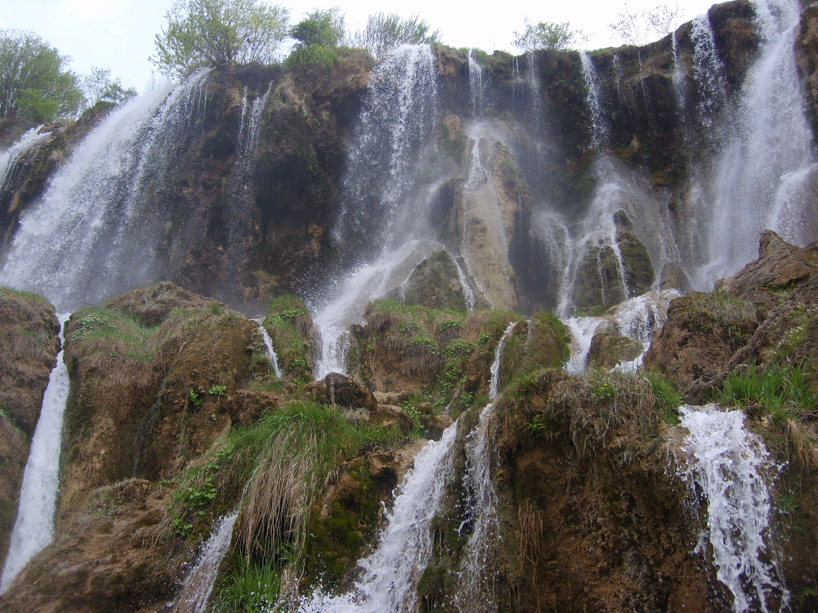 Waterfalls cascading down a rocky cliff
