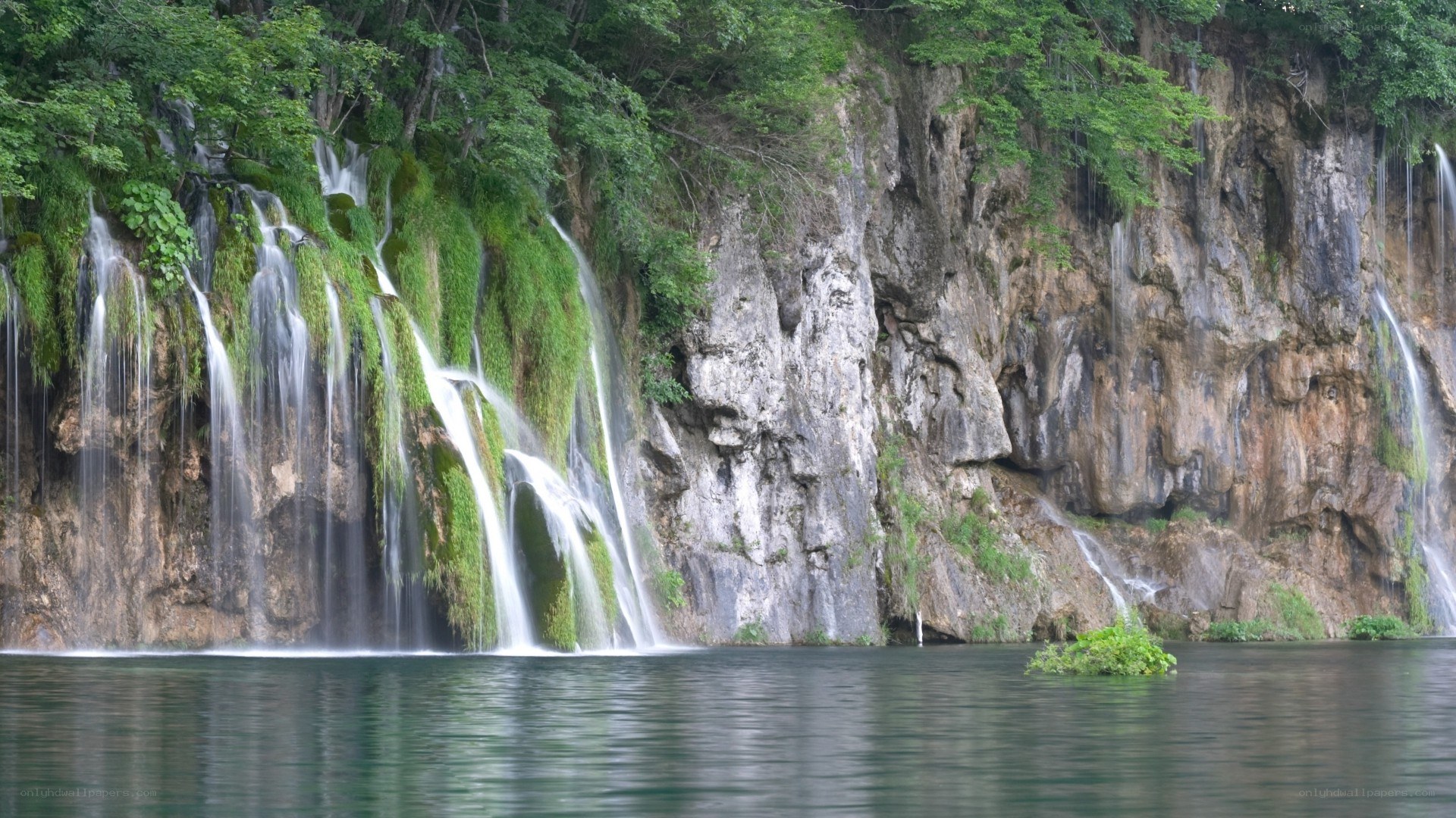 Waterfalls cascading into a lake