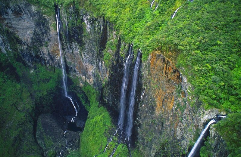 Waterfalls in lush green canyon