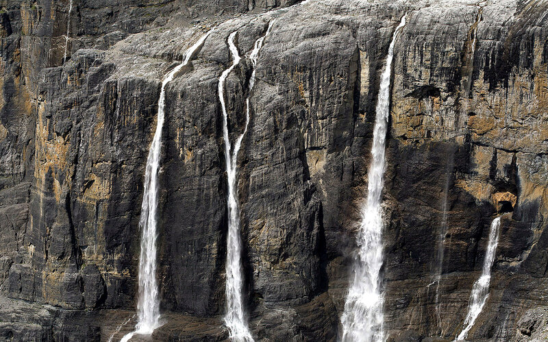 Waterfalls on Cliff Face — Gray