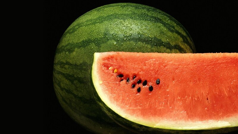 Watermelon slice on black background