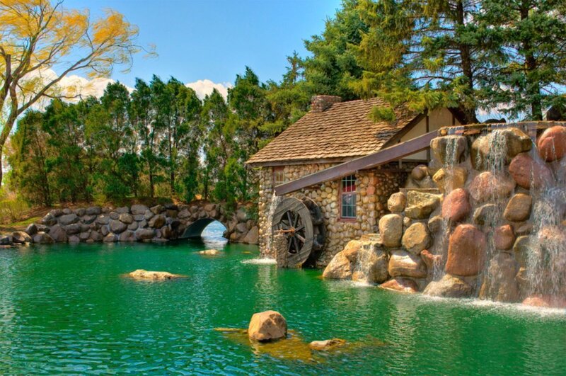 Watermill by a green pond