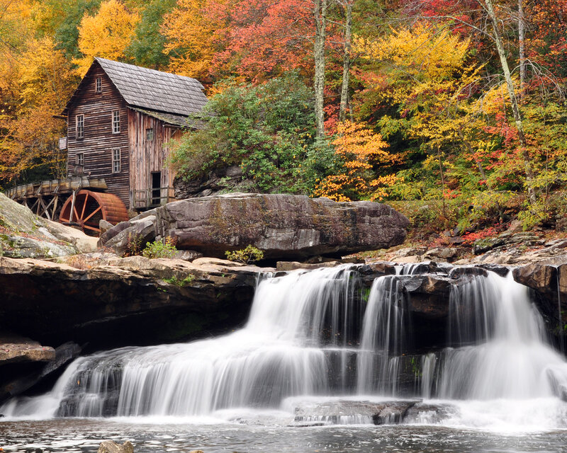 Watermill by a waterfall in autumn