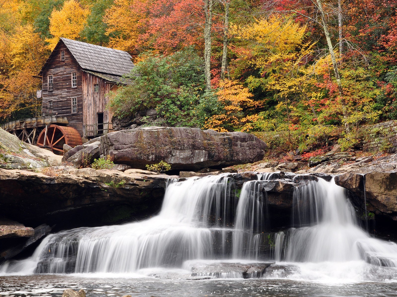 Watermill in autumn forest