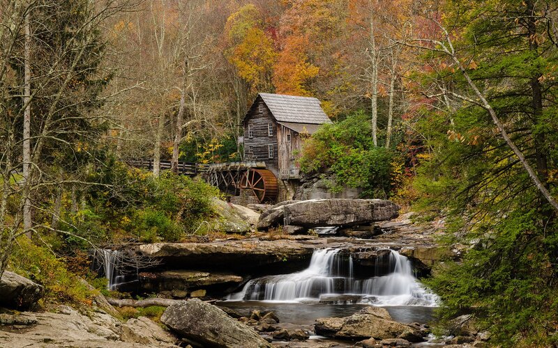 Watermill in autumn forest