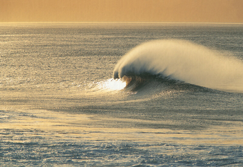 Wave breaking at sunset