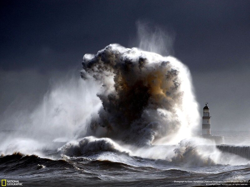 Wave crashes on lighthouse