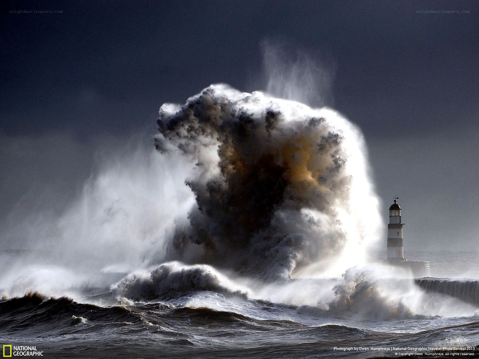 Wave crashes on lighthouse