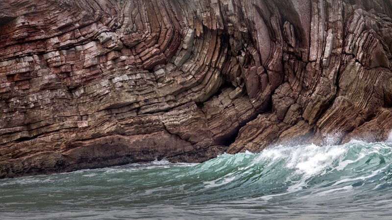 Wave Crashing Against Cliff
