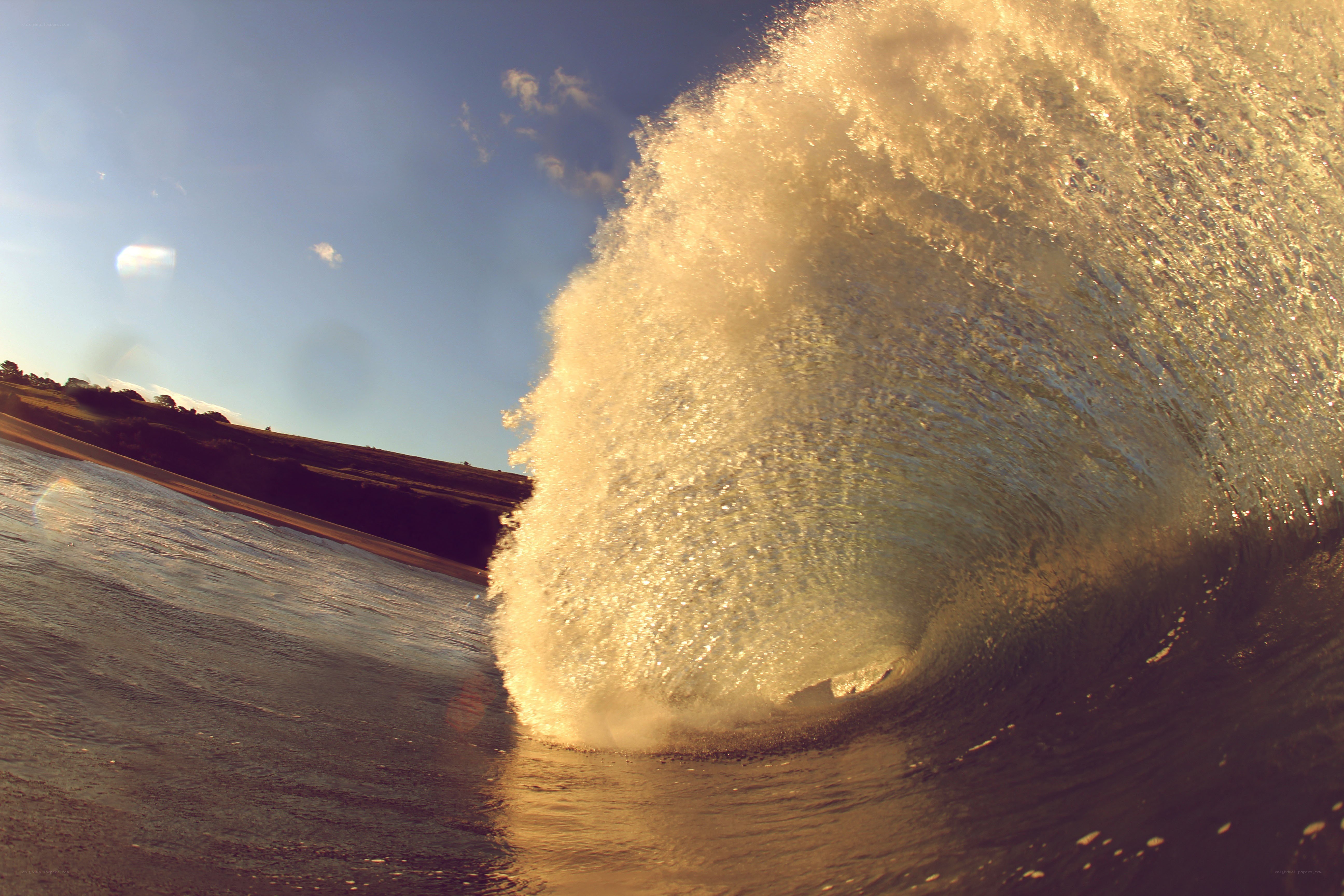 wave crashing at sunset