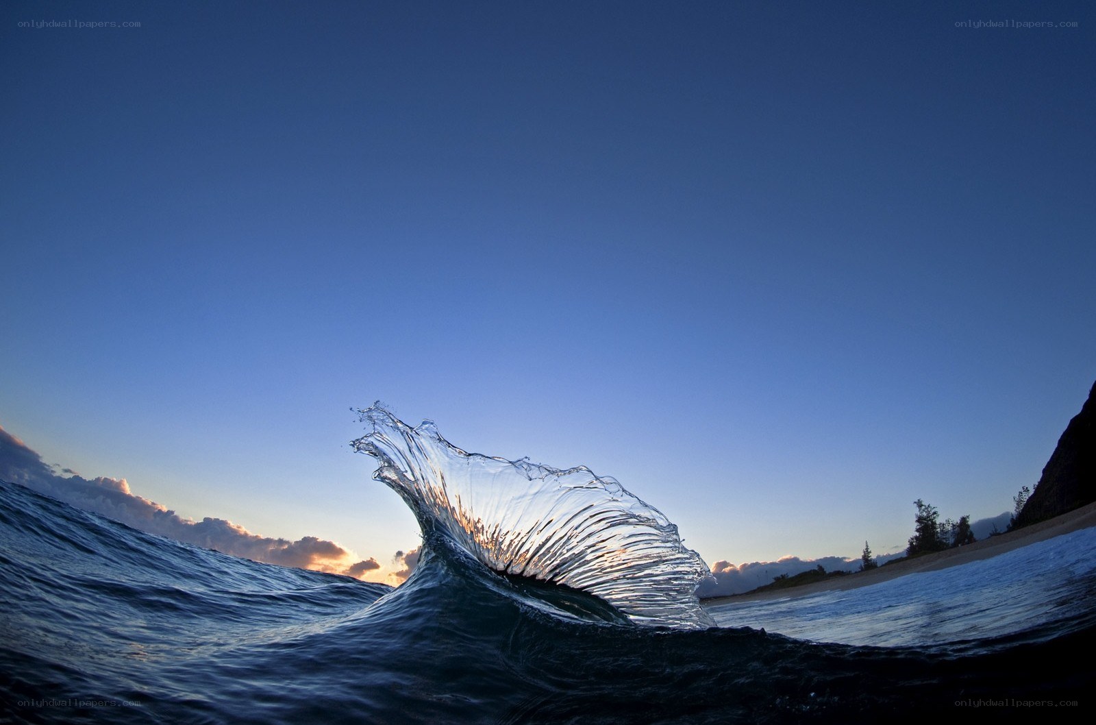 Wave crashing at sunset